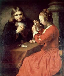 Un joven y una chica jugando a las cartas